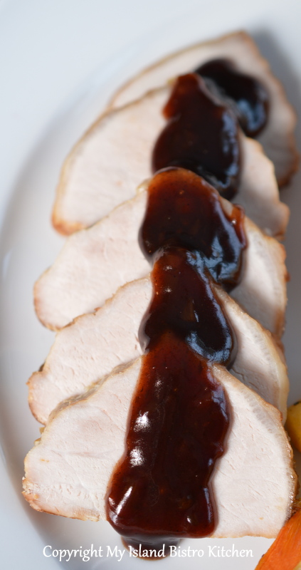 Sliced Pork Loin Roast Served with Pomegranate, Red Wine, and Black Garlic Sauce