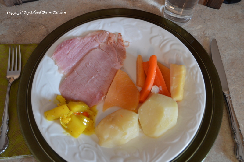 Boiled Ham Dinner consisting of sliced ham, potatoes, carrots, rutabaga, parsnips and homemade mustard pickles