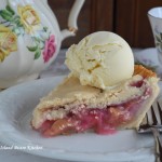 Slice of fruit pie with a scoop of ice cream on top