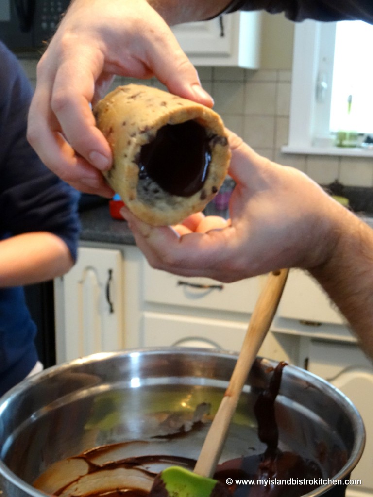 Lining a larger cookie shot glass with melted chocolate