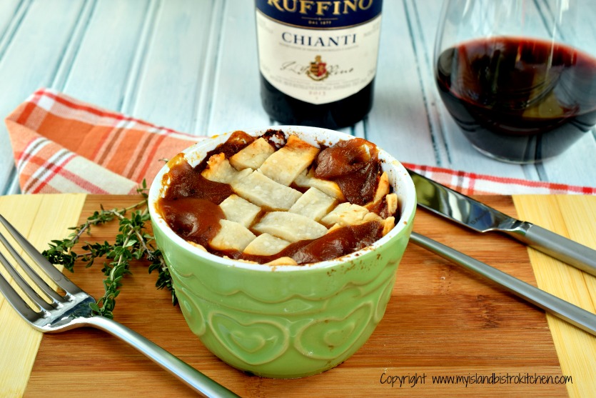 Beef Pot Pie in a green ramekin with glass of red wine in background