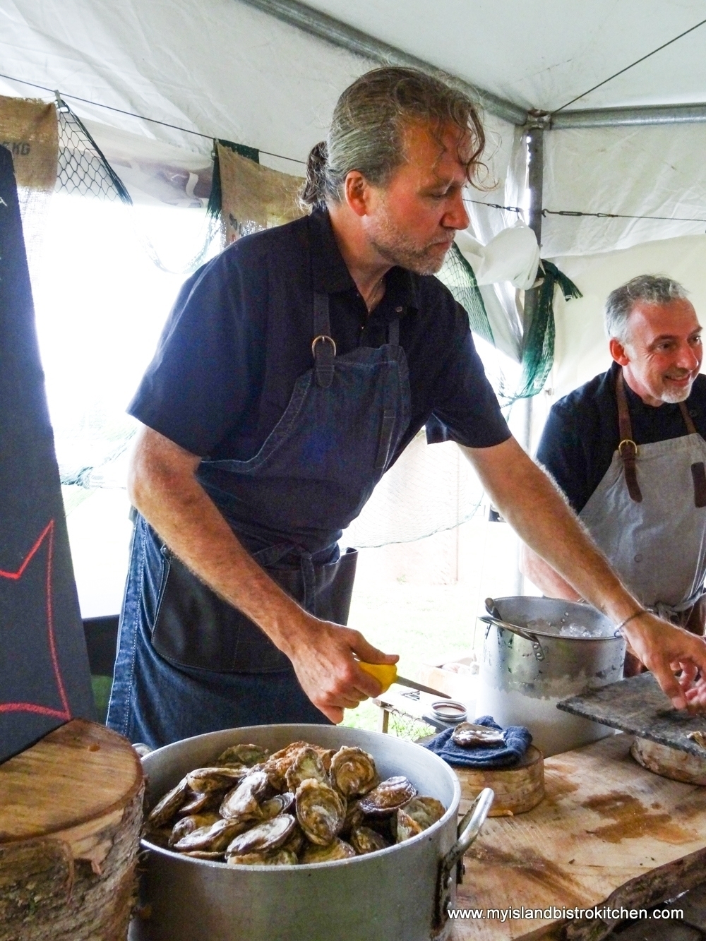 Chefs Michael Smith (l) and Paul Rogalski (r) Shuck Oysters at "Taste of Georgetown" Event
