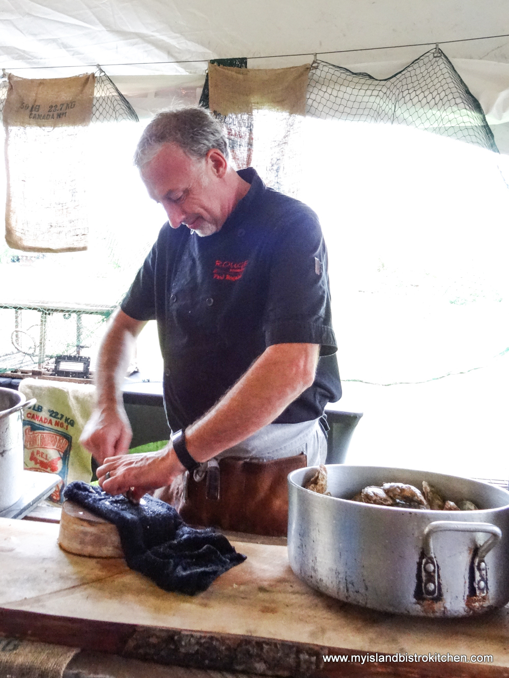 Chef Paul Rogalski shucks Brudenell Bully Oysters at Taste of Georgetown Event