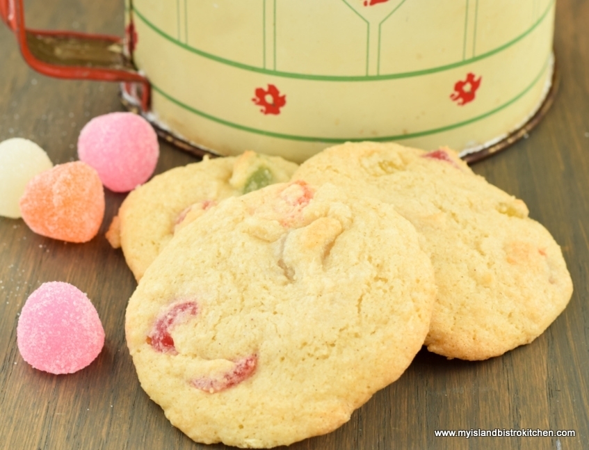 Three Gumdrop Cookies in front of an antique flour sifter