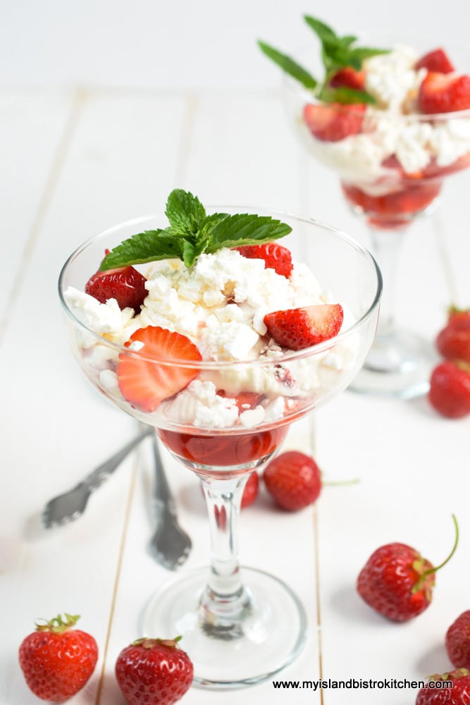 Pedestal dessert glass filled with Strawberry Eton Mess