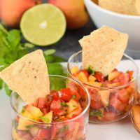 Small individual glasses filled with Fresh Peach Salsa