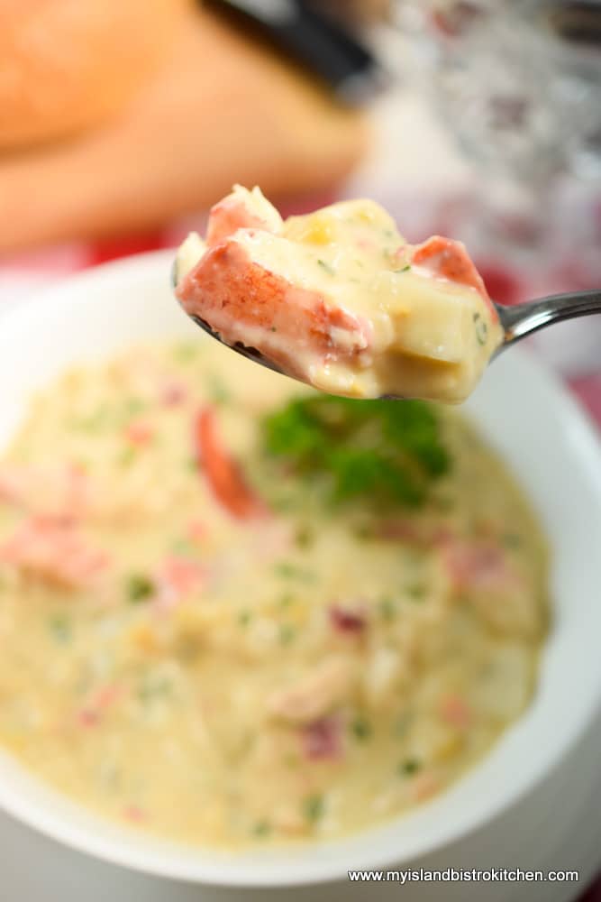 Spoonful of lobster, potato, and creamed corn chowder