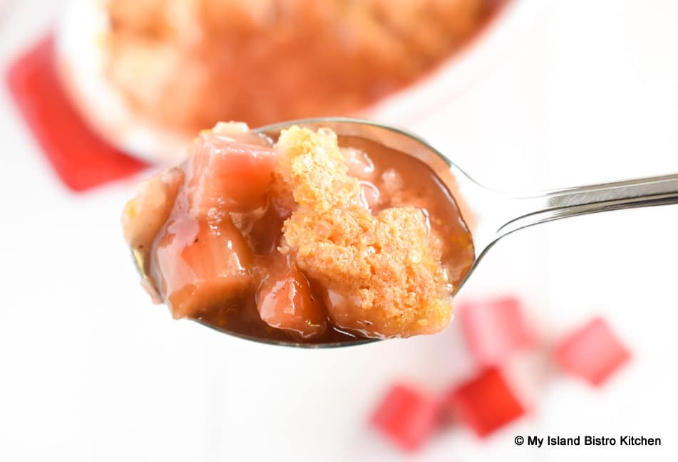 Spoonful of rhubarb dessert with biscuit topping