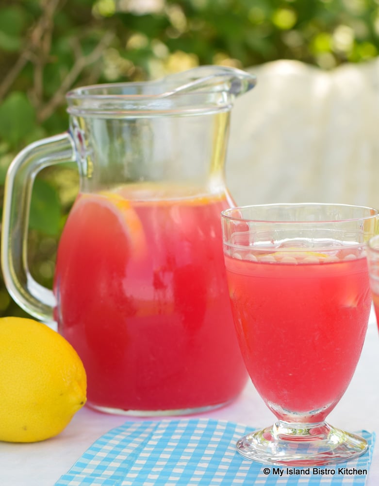Jug and glass of rosy lemonade