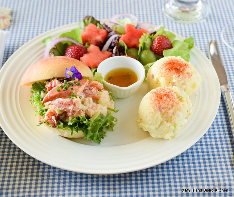 Plate of PEI Lobster Roll, Potato Salad, and Green Salad