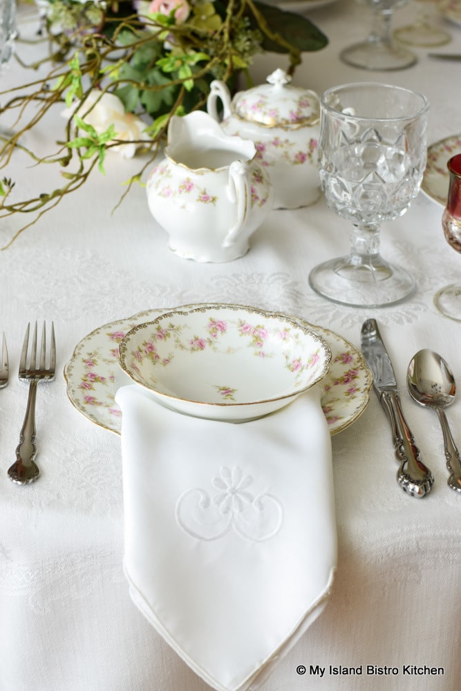 Placesetting with antique dishes with a pink and white design