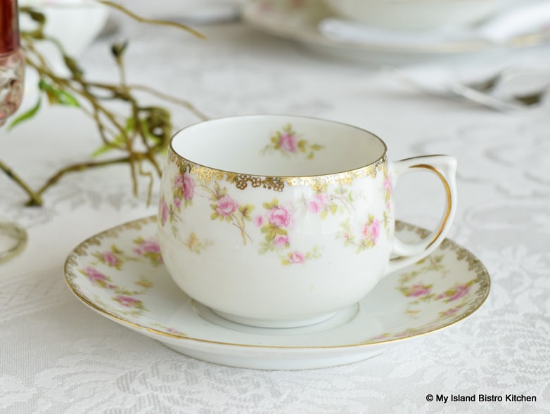 White cup and saucer with pink flowers and gold trim