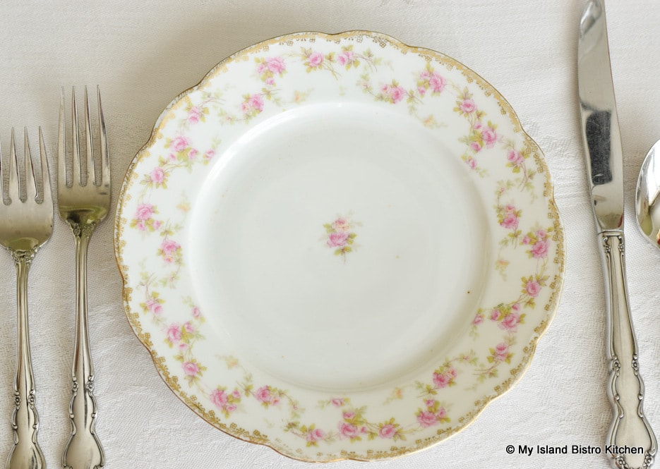 Top-down view of MZ Austria supper plate with pink roses around edge