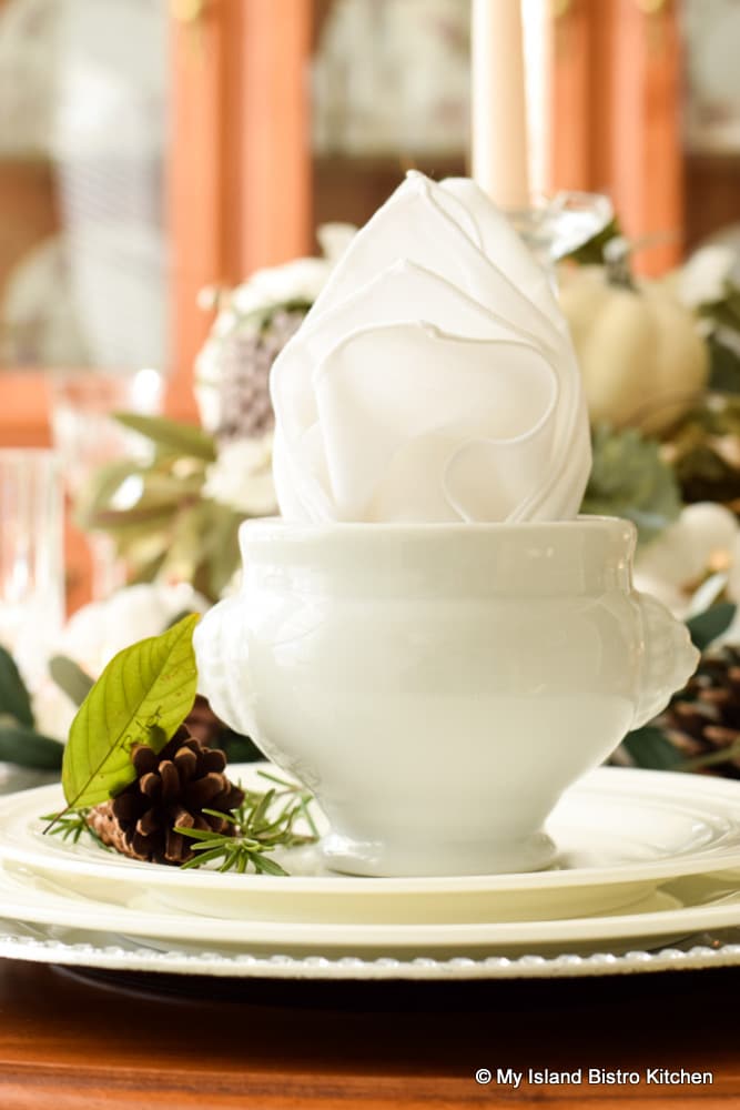 Miniature white soup tureens make ideal soup bowls and holders for the napkin