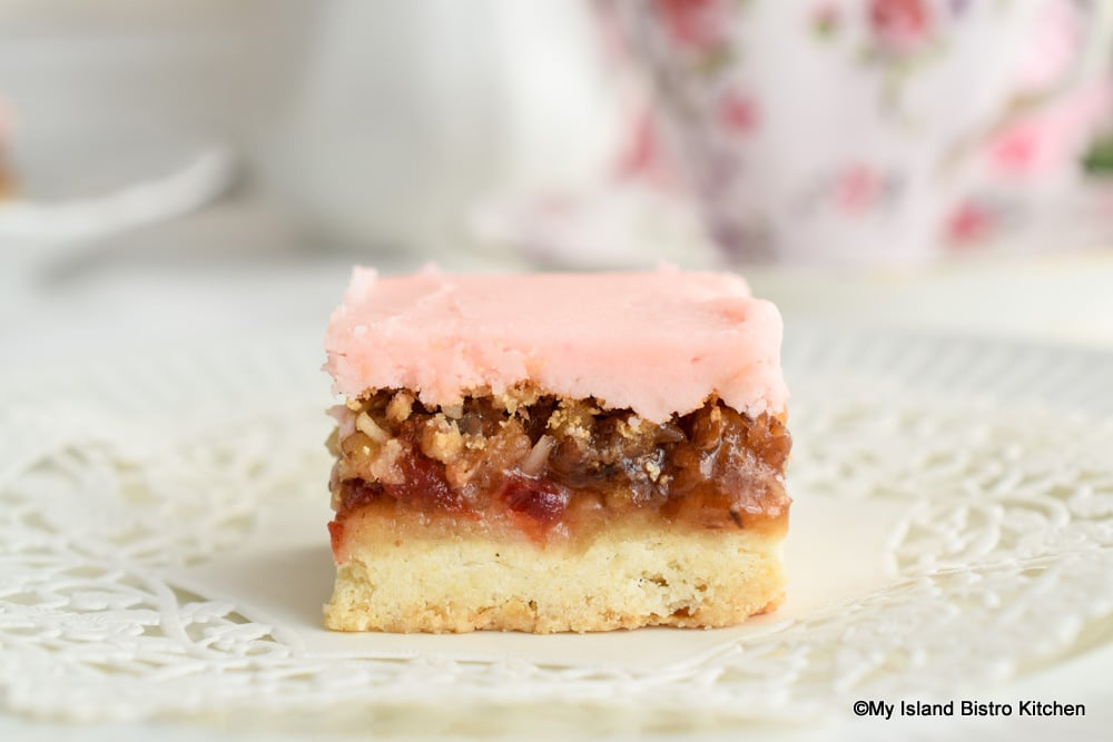 Shortbread bar with a delectable topping and pink icing