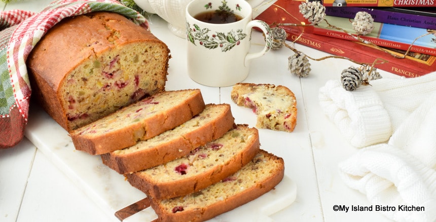 Slices of Christmas quick bread with a cup of tea in an antique mug