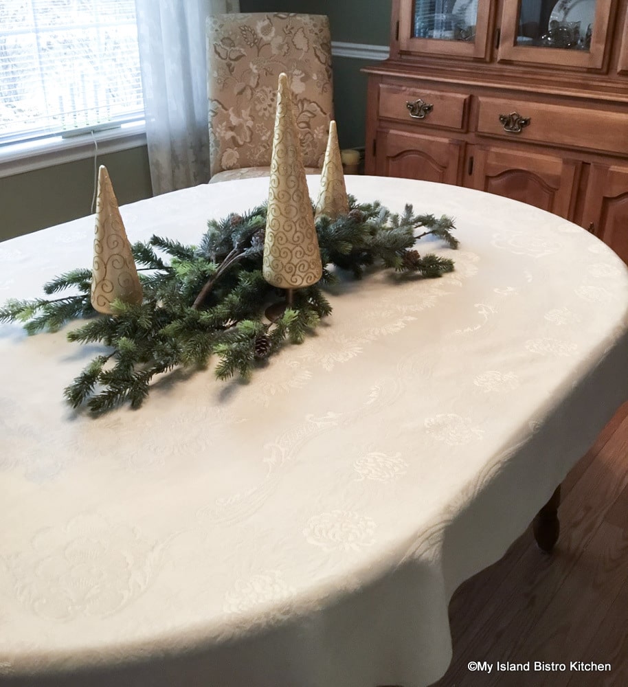 Adding gold-colored trees to a tablescape