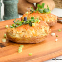 Twice-baked potatoes topped with melted cheese and pea shoots