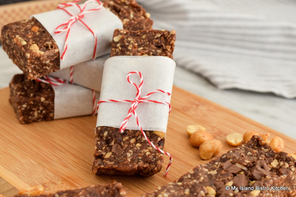 Close-up of Roasted Peanut and Mocha Energy Bars wrapped in parchment paper and tied with red-striped string