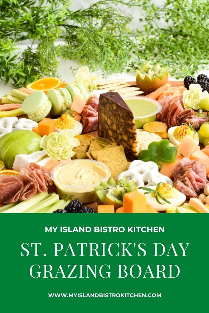 A grazing board filled with green, orange, and white foods for St. Patrick's Day