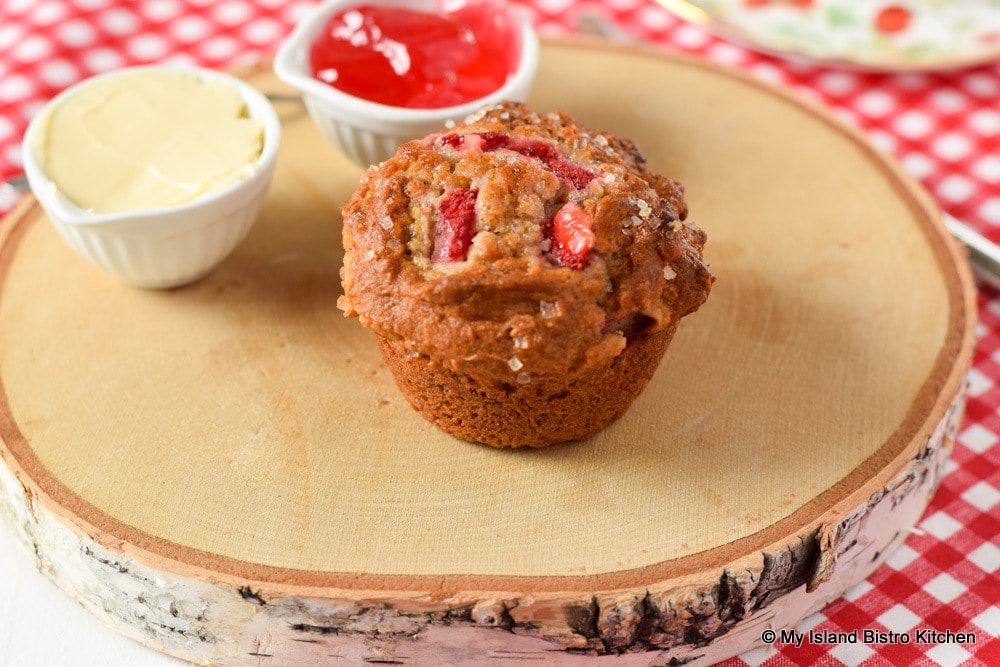 Strawberry Muffin on wooden board with rhubarb jelly and butter