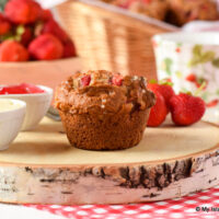 Strawberry Muffin on wooden board with box of strawberries in background