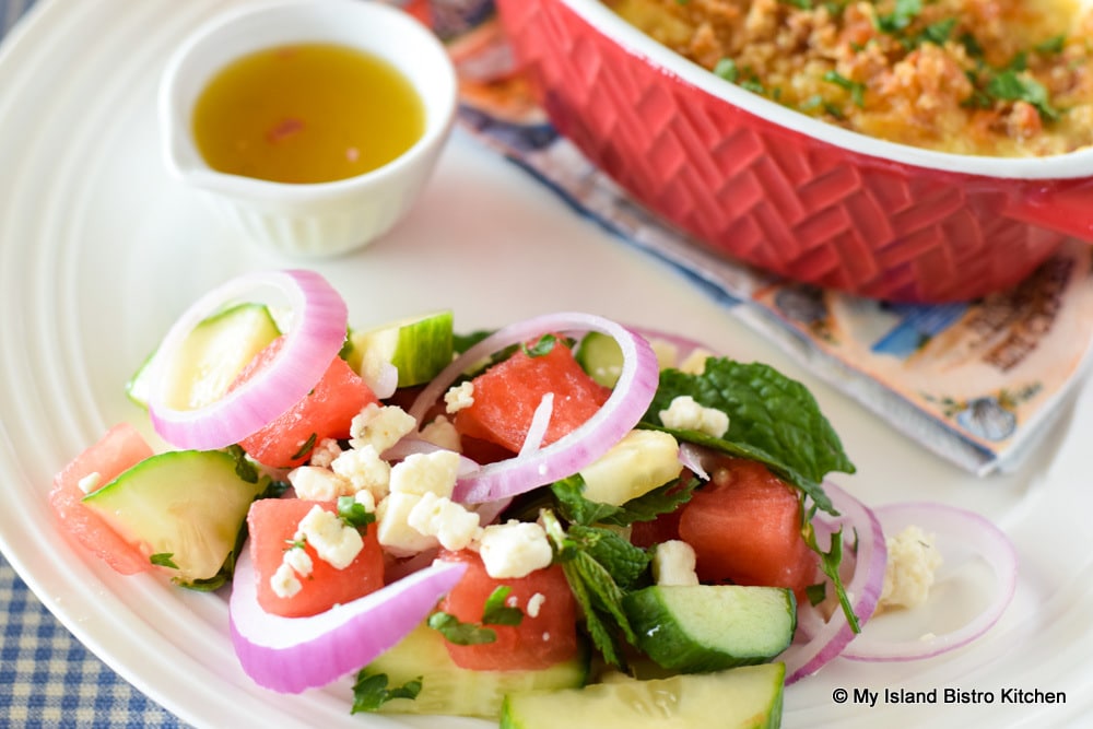 Colorful summertime salad featuring watermelon, English cucumber, red onion, and Feta