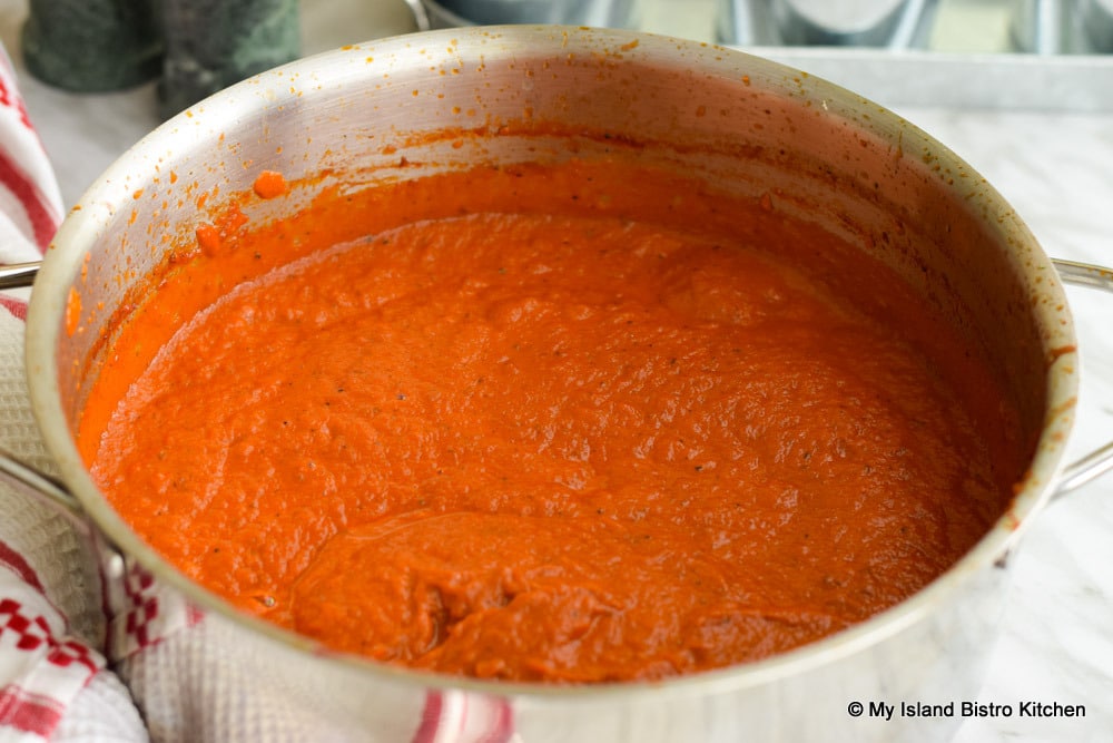 Pot full of bright red tomato and cheese-based Spaghetti Sauce