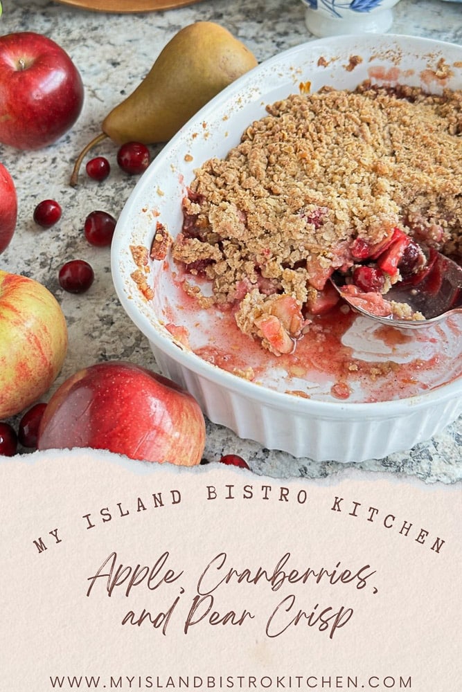 Baking Dish with Fruit Crisp. Apples, Pear, and Cranberries Surround the Dish