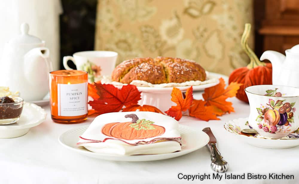 Tea table set with fall themed teacups and a plate of Pumpkin Scones