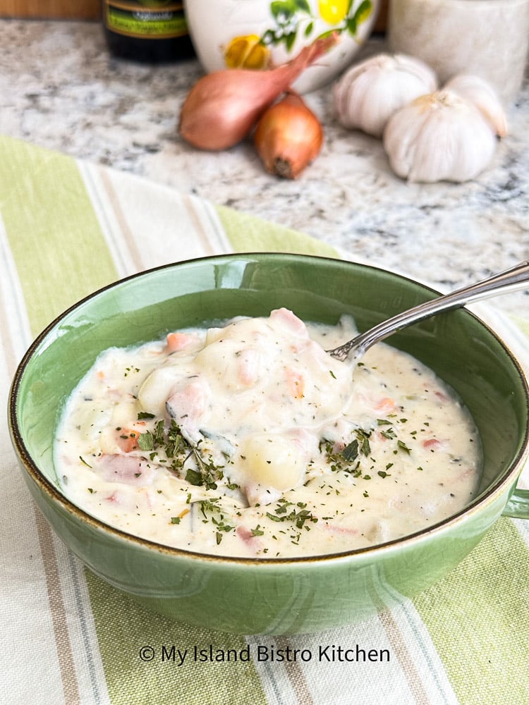 Spoonful of creamy Ham Chowder in green soup bowl