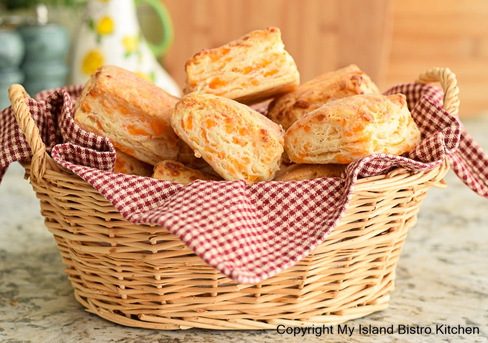 Napkin-lined wicker basket filled with homemade biscuits