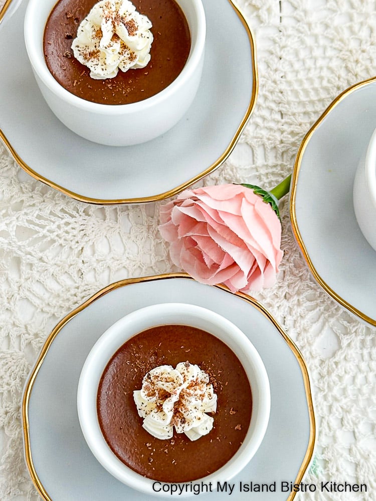 Tiny pots of chocolate custard topped with whipped cream