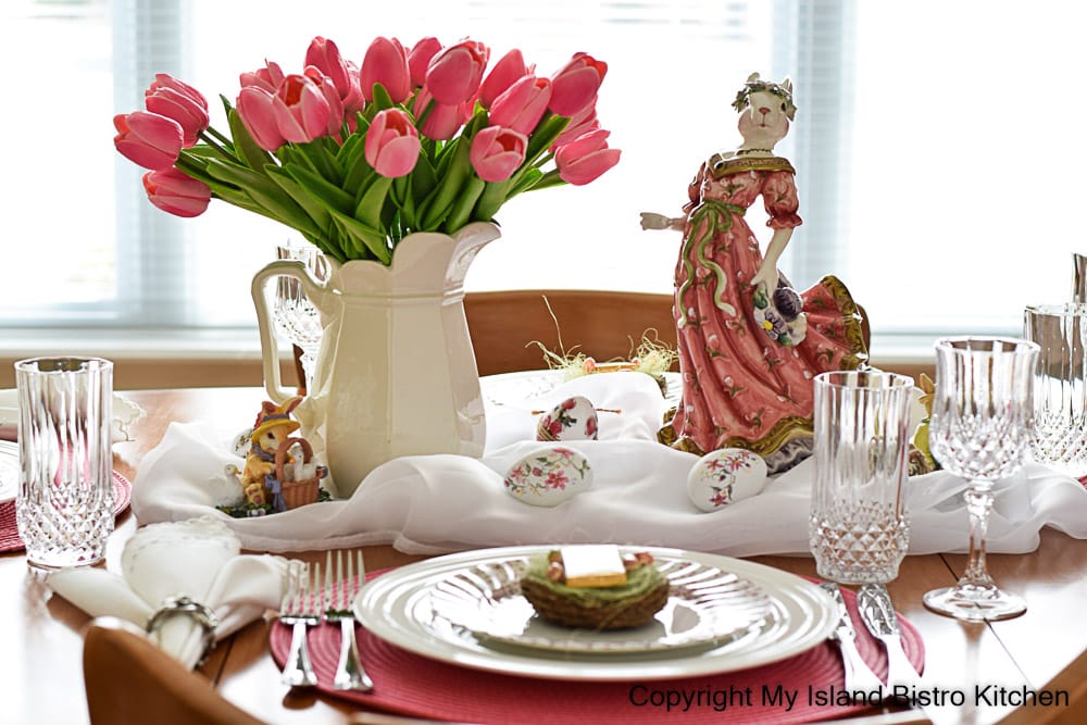 A pink bunny and a bouquet of bright pink tulips are the focal point of this seasonal tablesetting