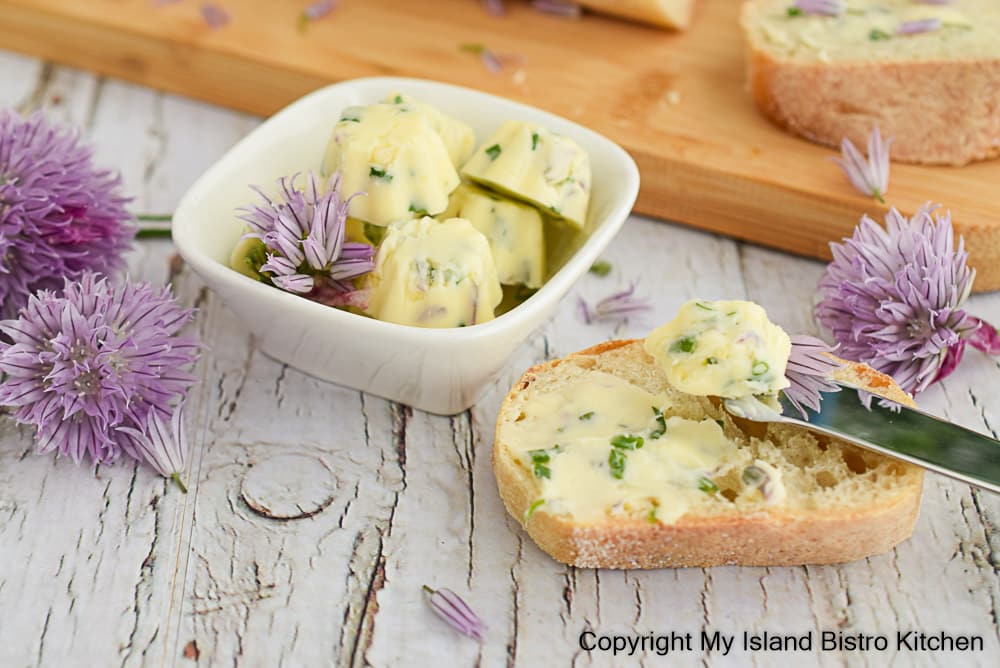 Small bowl filled with tiny pats of compound butter