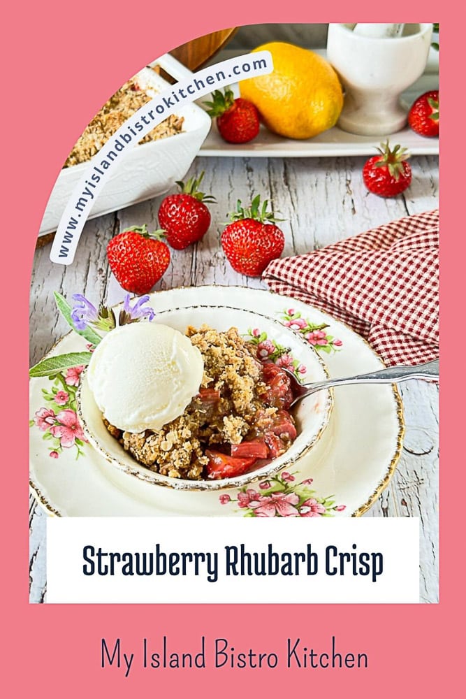 Bowl of Strawberry Rhubarb Crisp topped with a scoop of vanilla ice cream