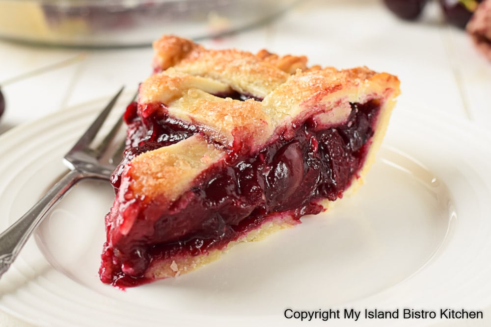 Lattice-topped Pie Slice on White Plate