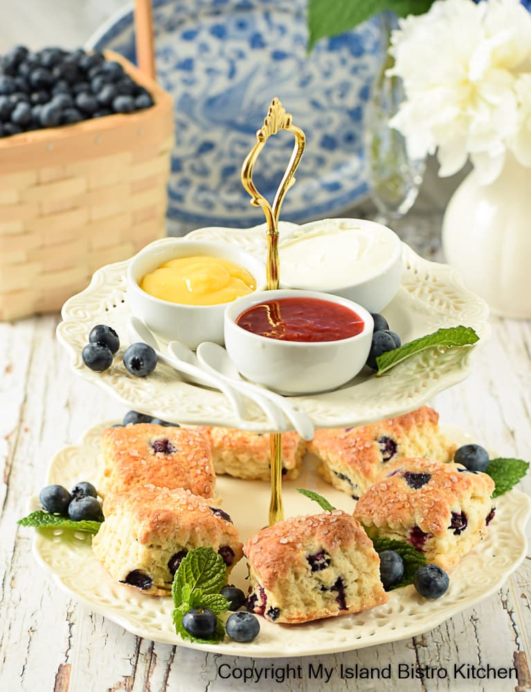 Two tier served filled with homemade scones and condiments