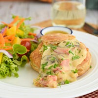 Lobster in a Cream Sauce served in puff pastry shells alongside a mixed green salad