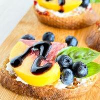 Tiny appetizers made with peaches, blueberries, and cold cuts