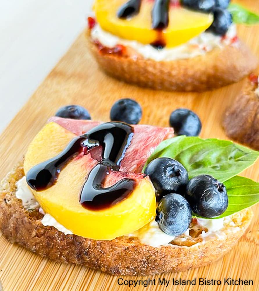 Tiny appetizers made with peaches, blueberries, and cold cuts