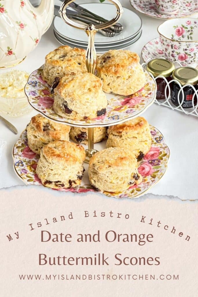 Two-tier server filled with homemade scones. Pretty pink floral teaset is in the background.