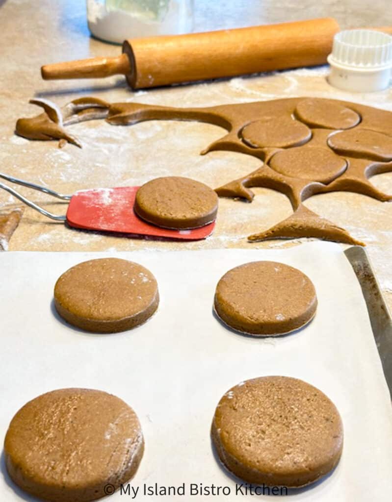Rolling Pin, Cookie Dough, and Cut out Cookies on Baking Sheet