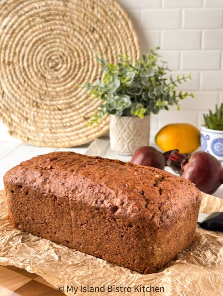 A no-yeast bread sits on parchment paper with beets and lemon in the background